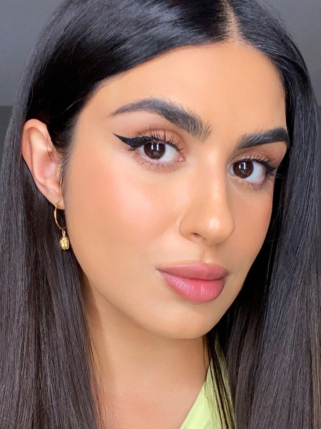 Close-up of Kendal Fedail rocking a natural makeup look with a bold cat eye Desktop