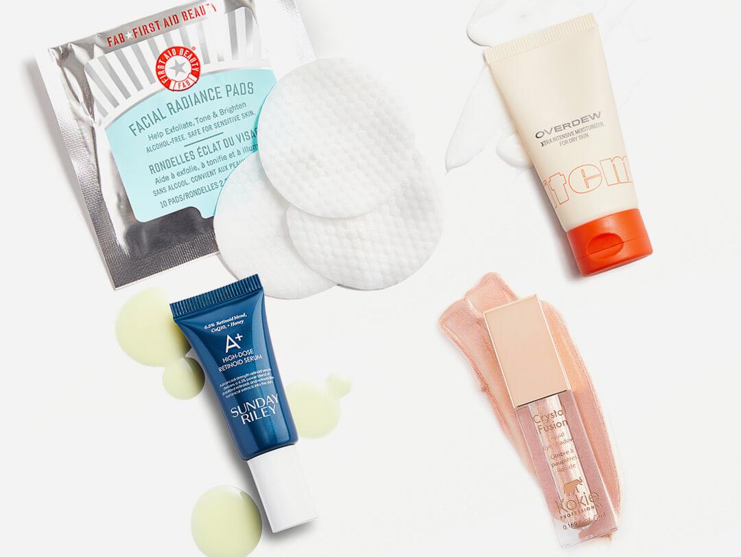 Skincare and makeup products from various brands swatched on white background Desktop