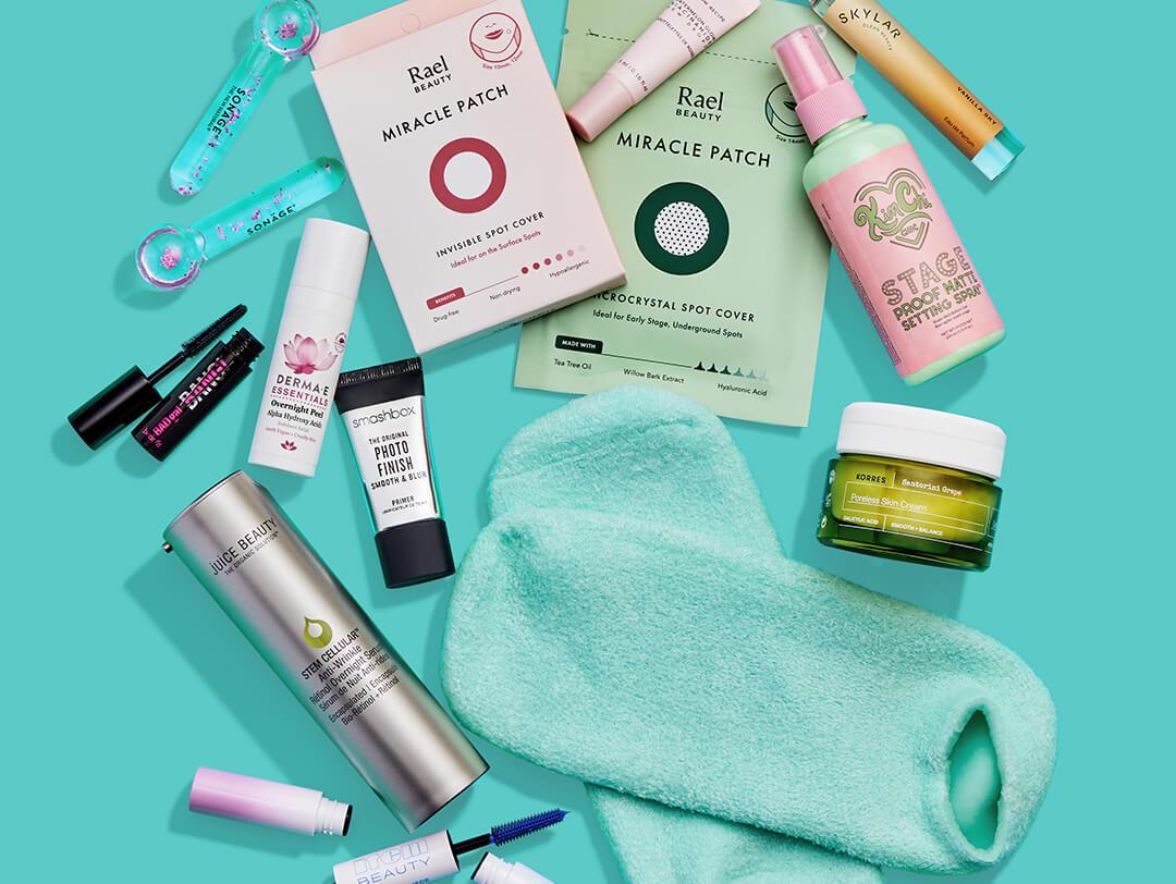 Beauty and makeup products from various brands scattered on teal background Desktop