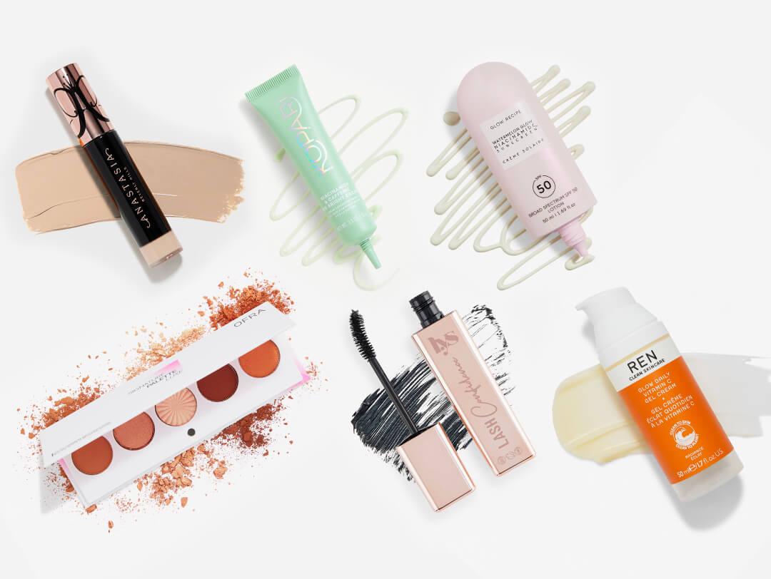 Skincare and makeup products from various brands on white background Desktop