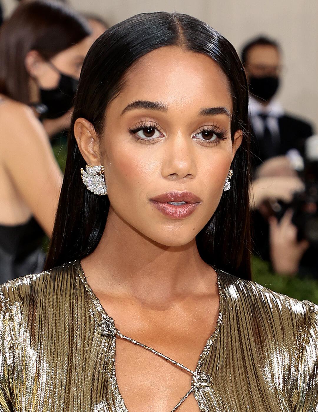 Laura Harrier looking elegant in a long and sleek hairstyle and textured gold dress Desktop