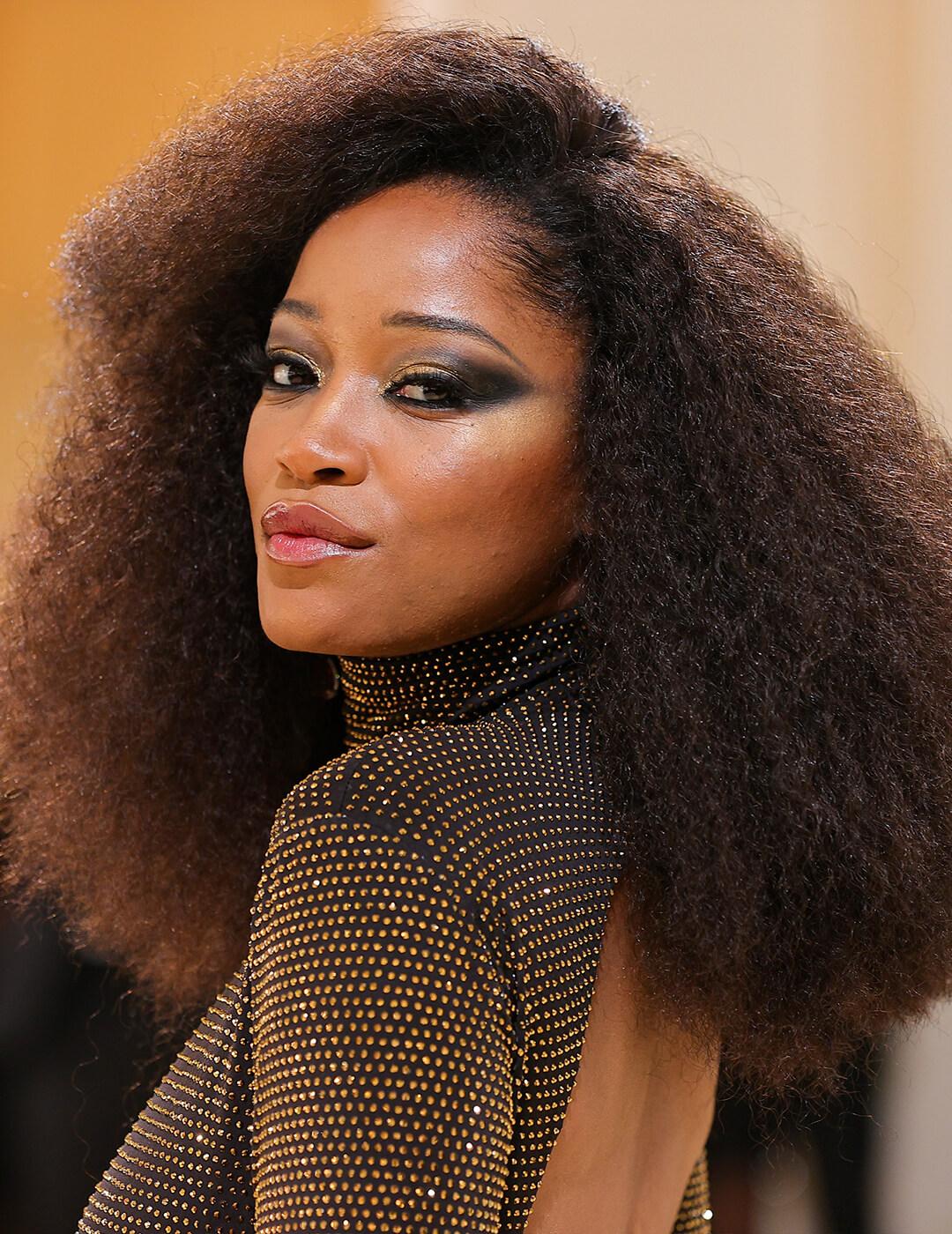 Keke Palmer rocking an afro and black and gold sequined dress Desktop