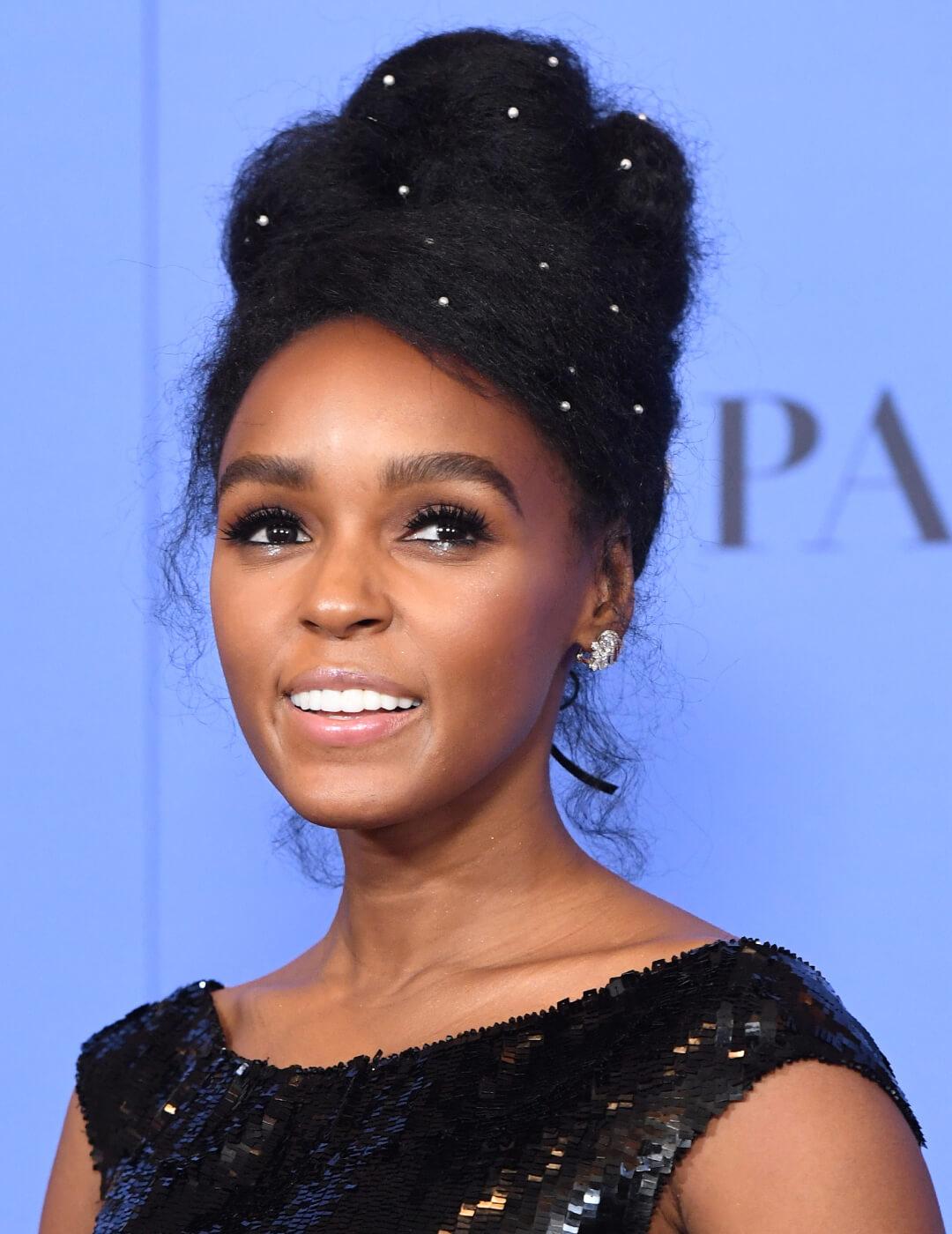 Janelle Monae rocking an updo hairstyle embellished with pearls and black sequined dress Mobile
