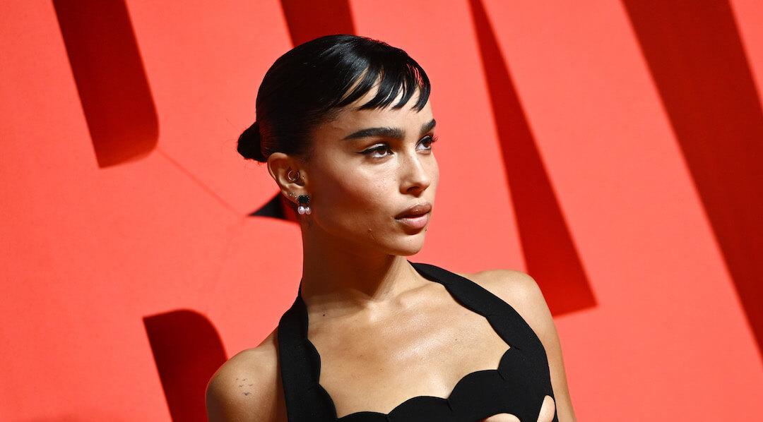 A photo of Zoë Kravitz with short baby bangs wearing a black halter-neck top long gown Desktop
