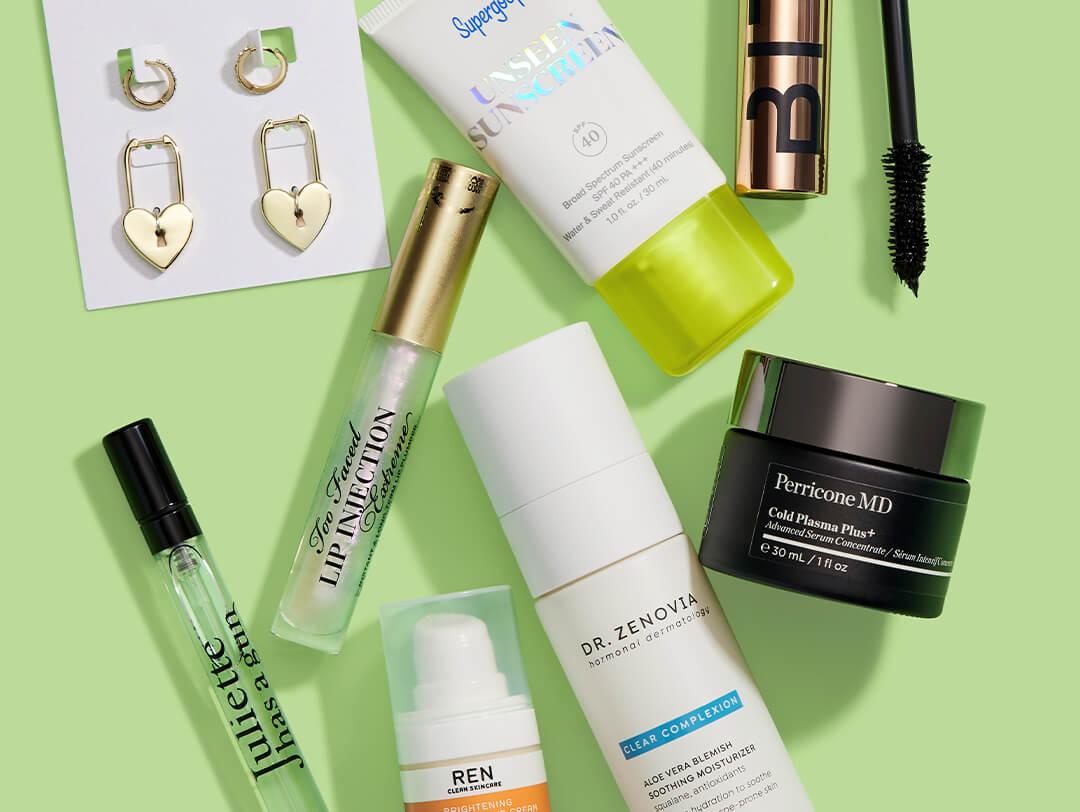 Makeup, skincare, and beauty products and tools from various brands scattered on light green background Desktop