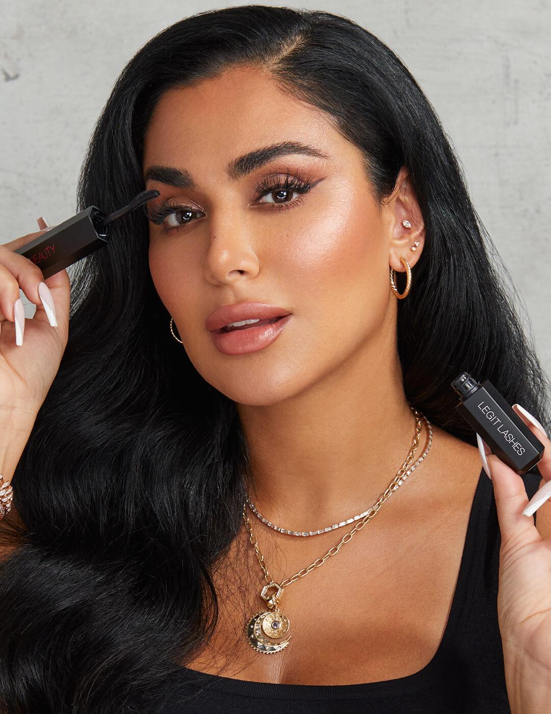 Glam Huda Kattan applying mascara on her lashes Desktop