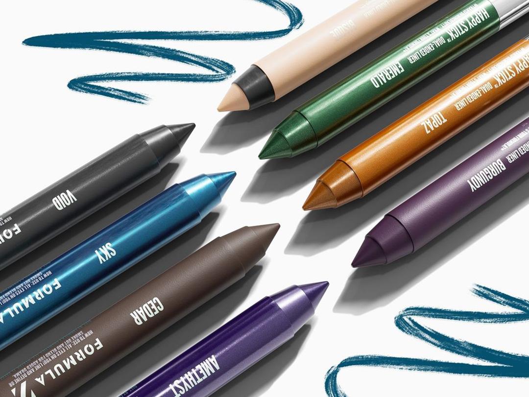 A closeup image of different colors of eyeliners with two swatches Desktop