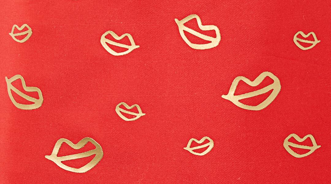 Red fabric with gold lips pattern Desktop