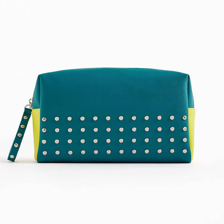 The March 2020 Glam Bag Ultimate bag is blue-green with silver studs and neon yellow accents Desktop