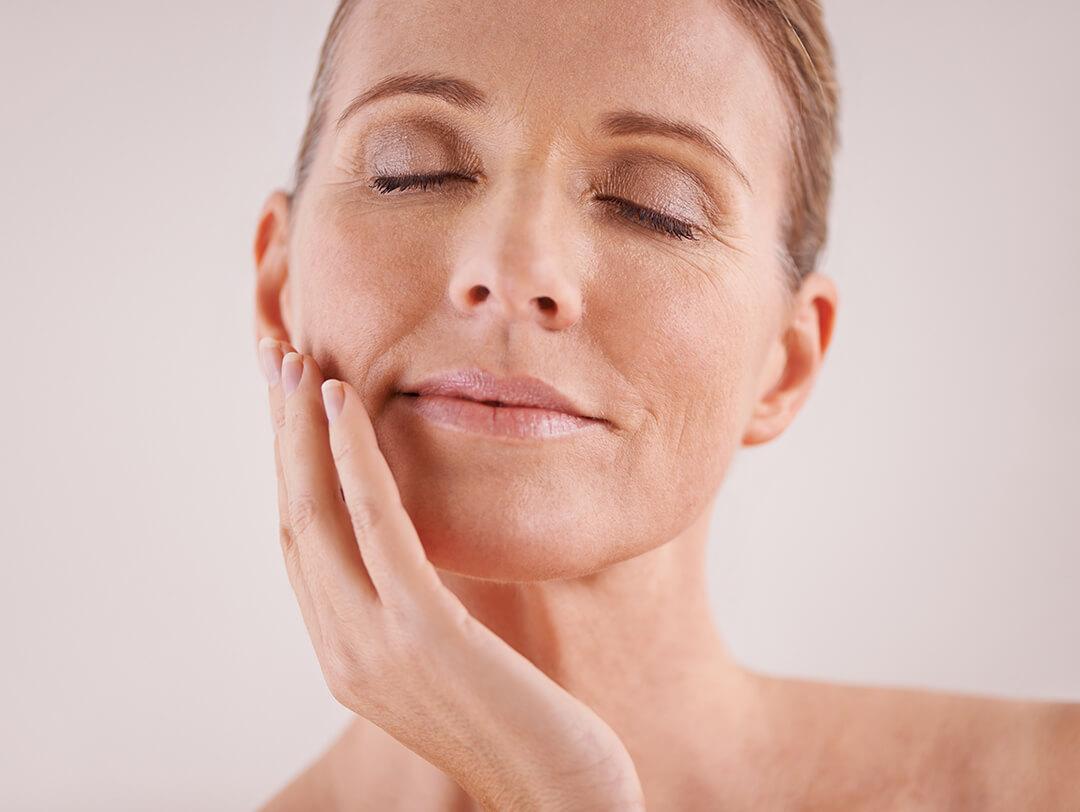 Close-up of a mature woman posing with eyes closed Desktop