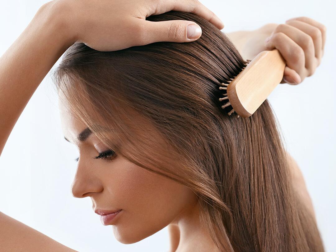 Young woman brushing her long, beautiful hair Desktop