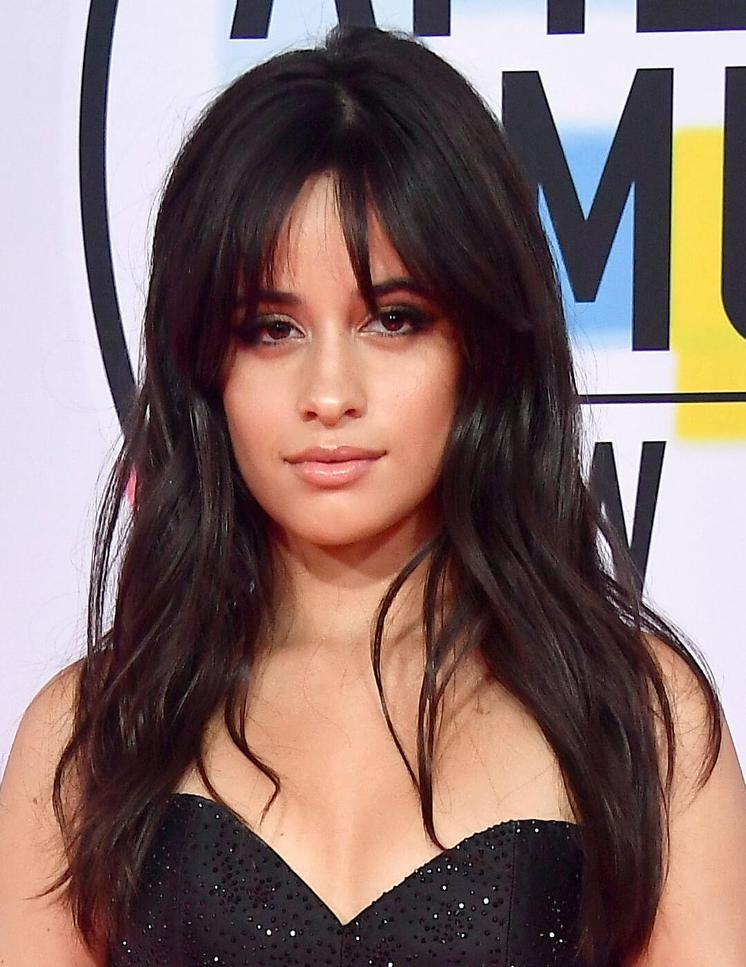 A photo of Camila Cabello with a soft shag wearing a black dress Mobile