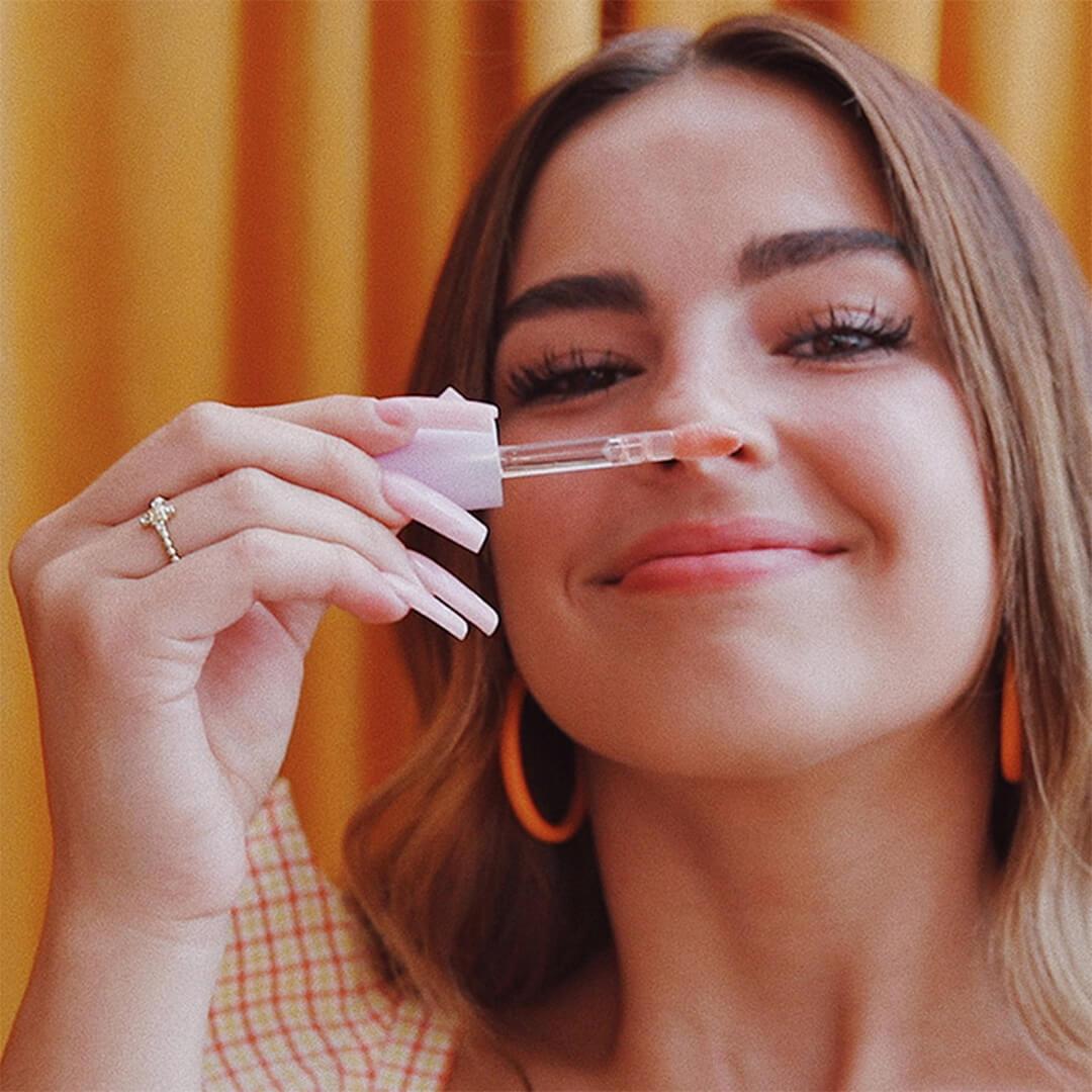 Addison Rae smelling one of her lip products Desktop