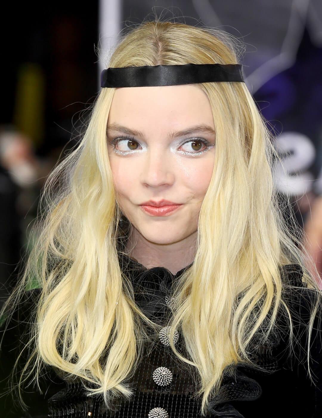 A photo of Anya Taylor-Joy looking cute on a baby blonde hair color Mobile