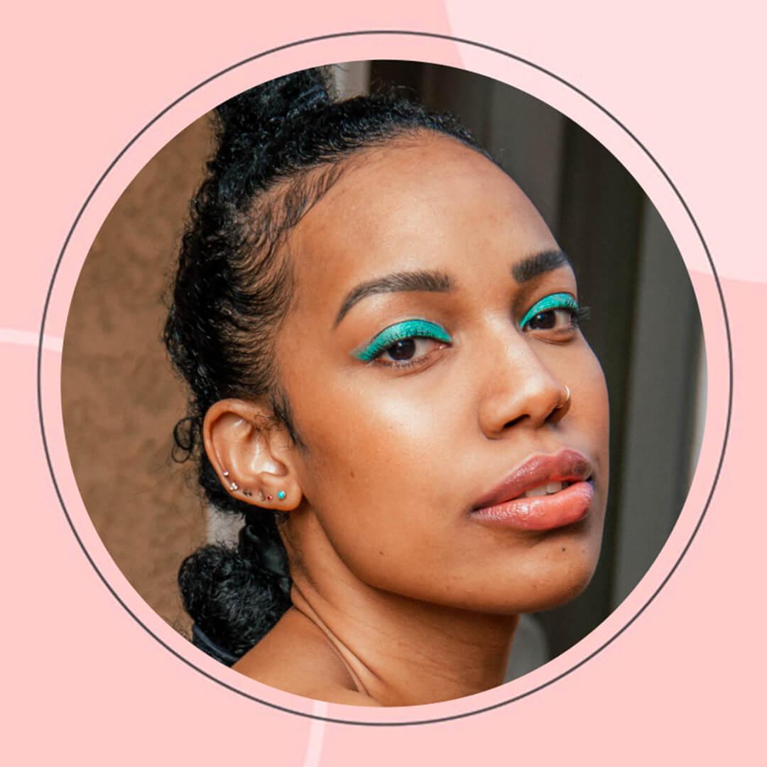 Profile image of Bianca Alexander rocking a bold, green eyeliner makeup look in a pink border frame Mobile