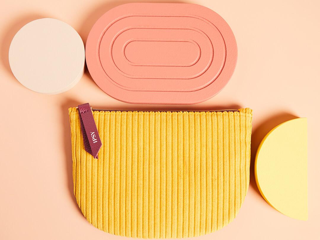 IPSY September 2020 Glam Bag and round blocks on peach background Desktop