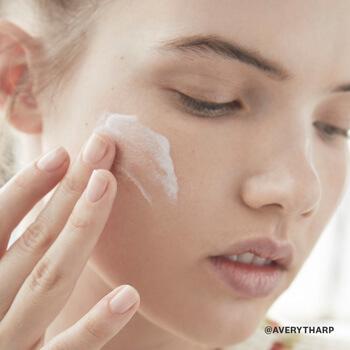 A model slathers on a moisturizer to keep her skin hydrated. Mobile