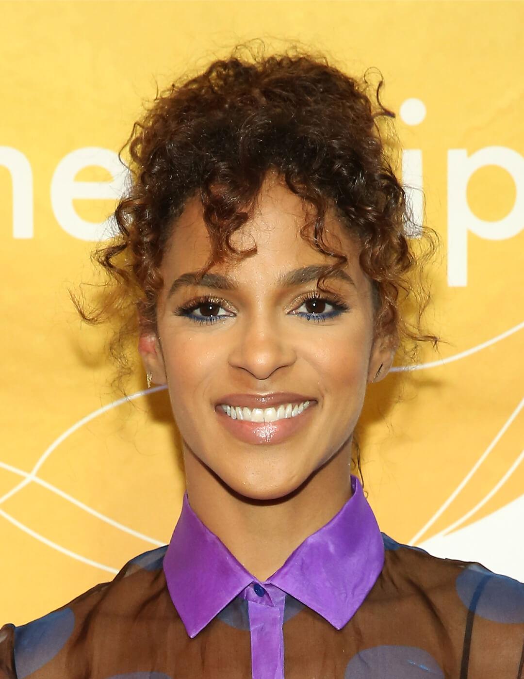 Megalyn Echikunwoke smiling and rocking her curly bangs Desktop