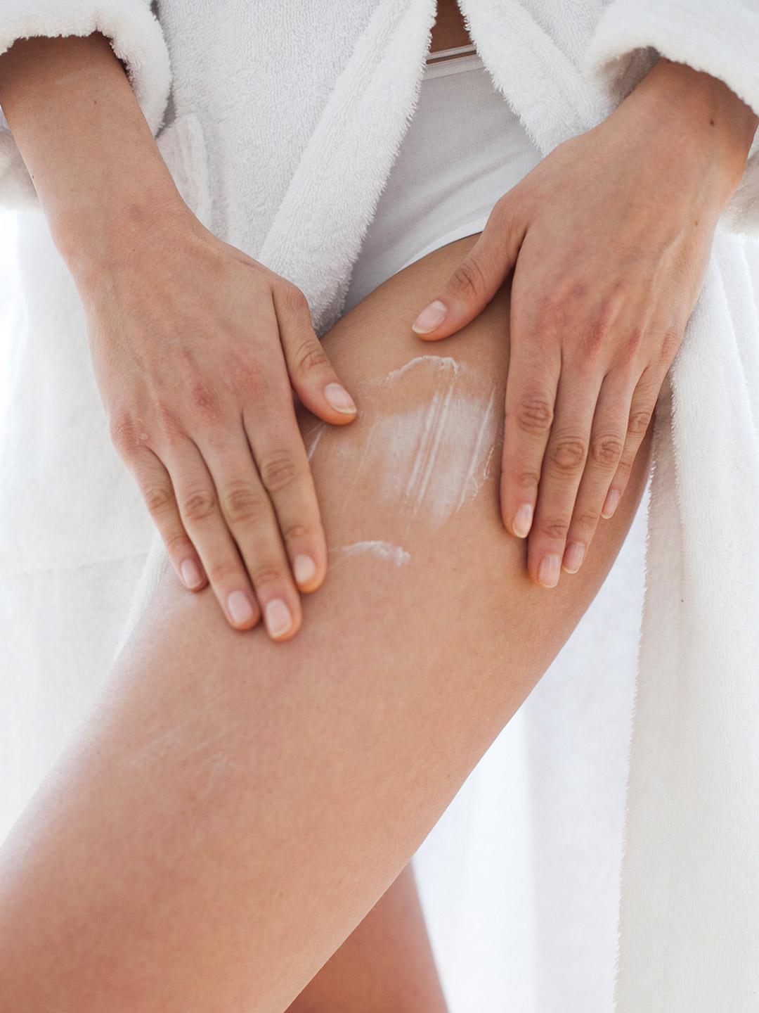 A photo of a model's leg applying a cream Desktop