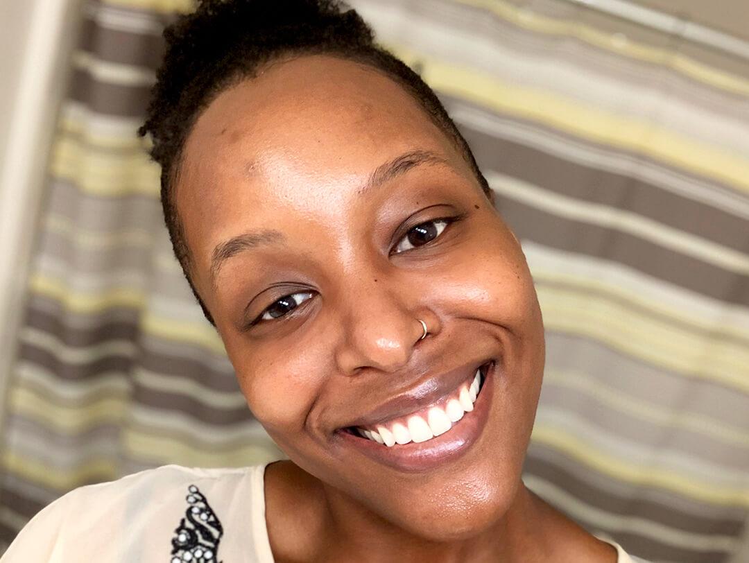 Image of a woman with a clean face smiling big Desktop