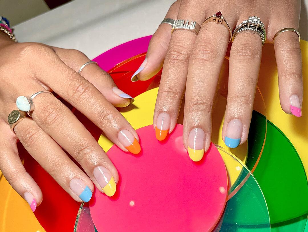 Close-up of a woman's hand with pastel colored french tips Desktop