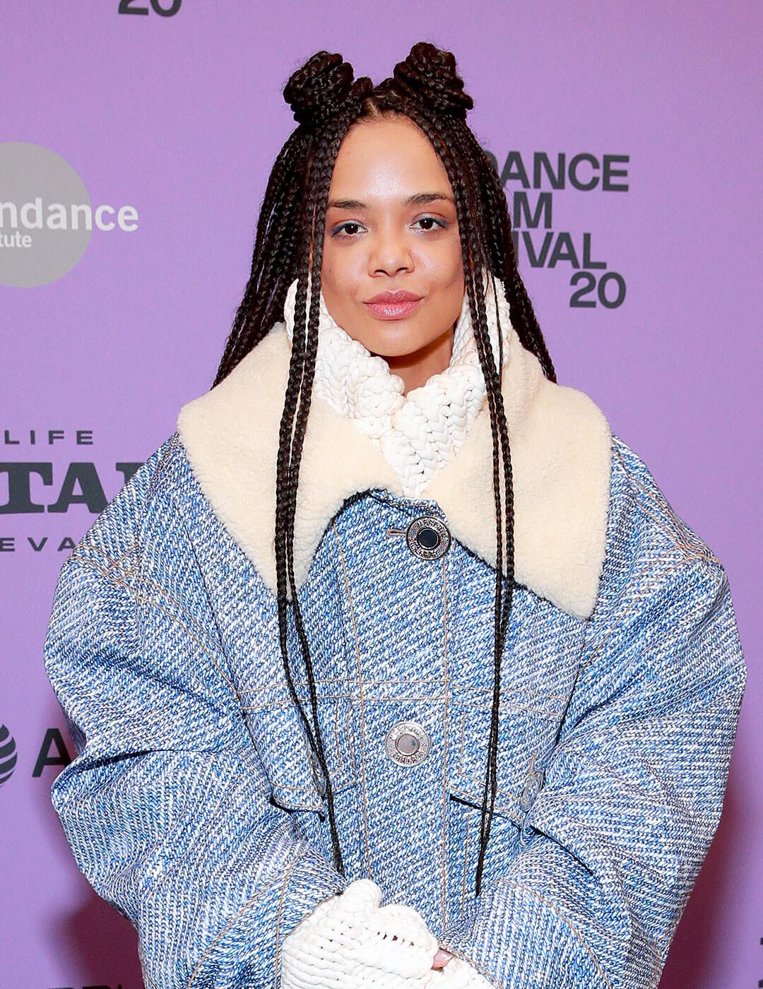 Tessa Thompson wearing a denim winter jacket and rocking a braided hairstyle with space buns Desktop
