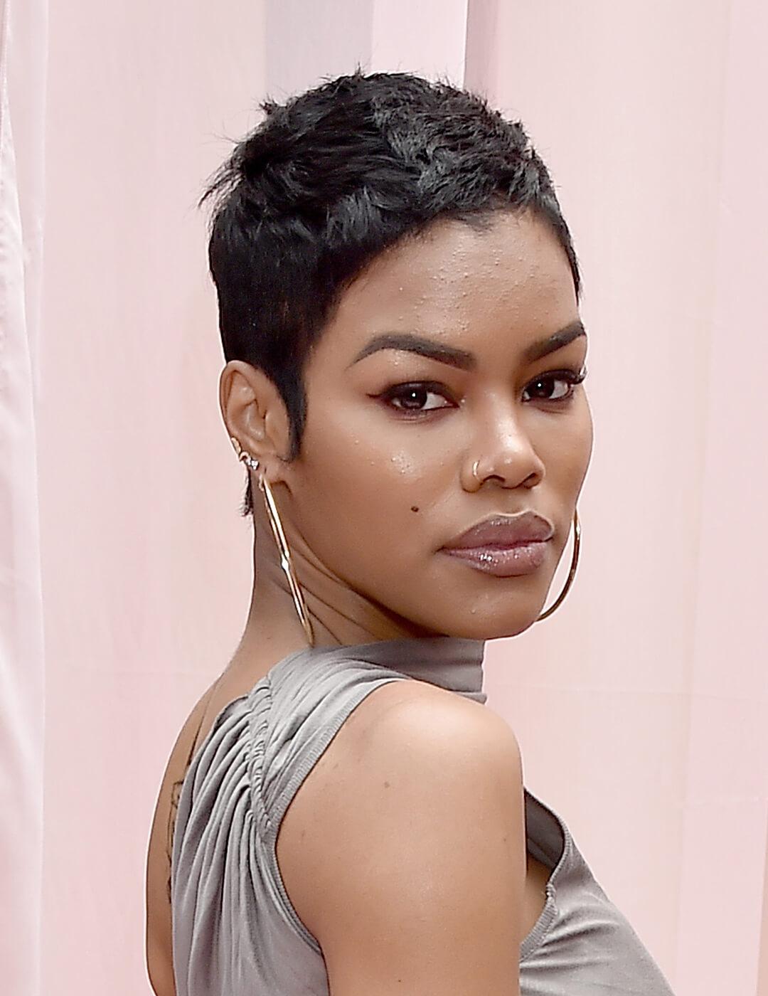 Teyana Taylor rocking her pixie cut hairstyle in a silver dress Mobile