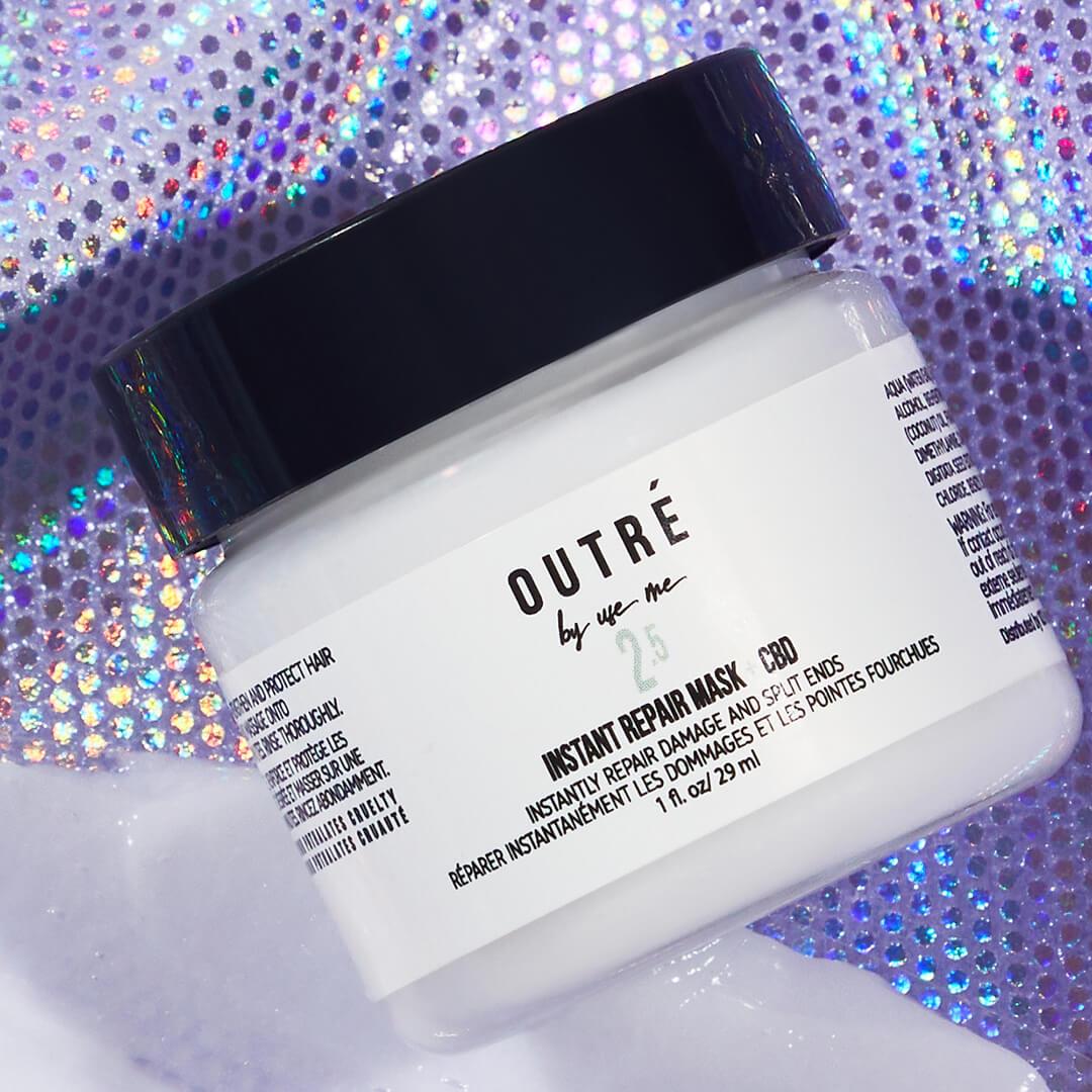 Close-up image of a jar of OUTRÉ BY USE ME Instant Repair Hair Mask + CBD on purple sequins background Mobile