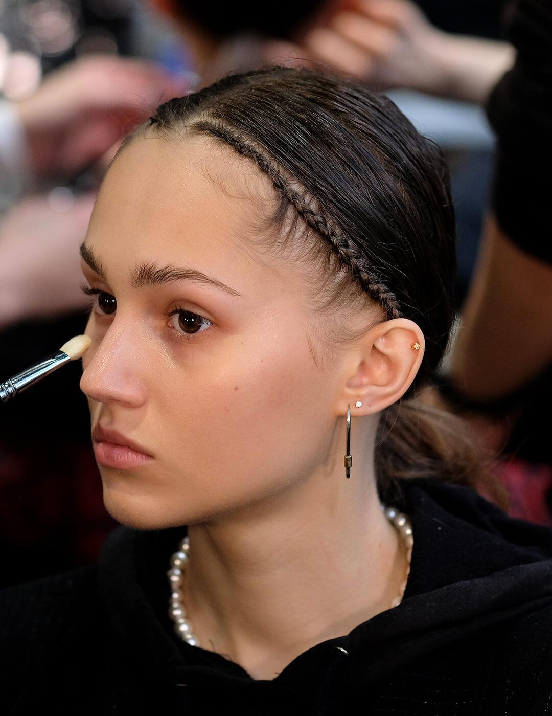 A photo of a model being dolled up backstage for Dion Lee during New York Fashion Week: The Shows Mobile