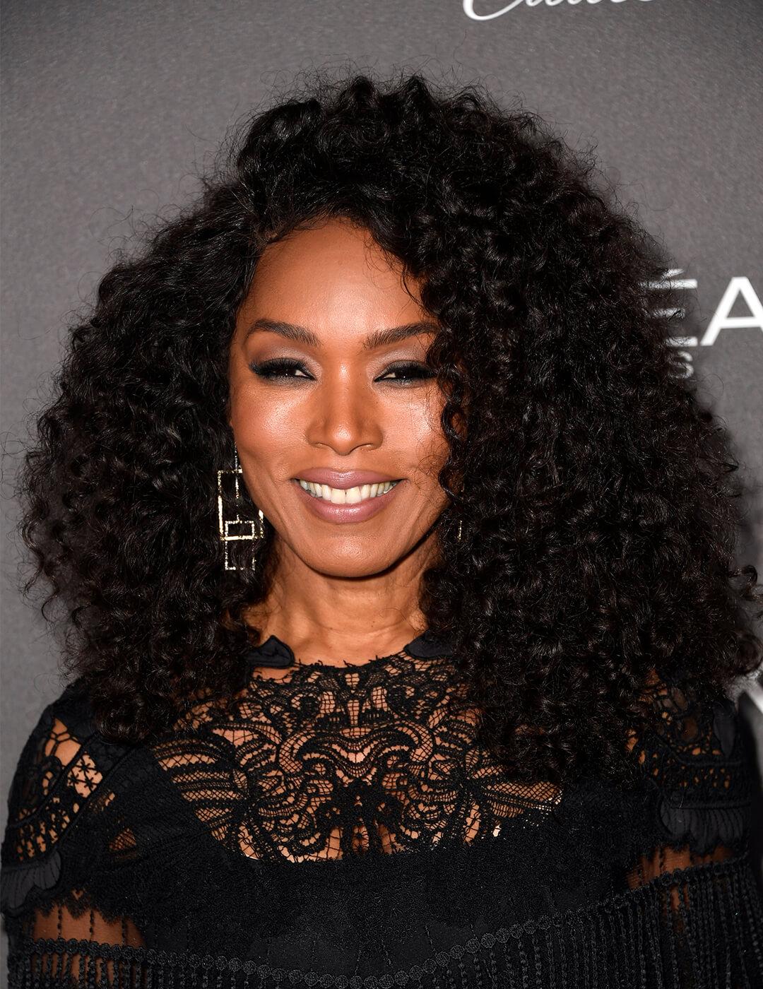 Angela Bassett rocking her curls in a black, lacy dress Mobile