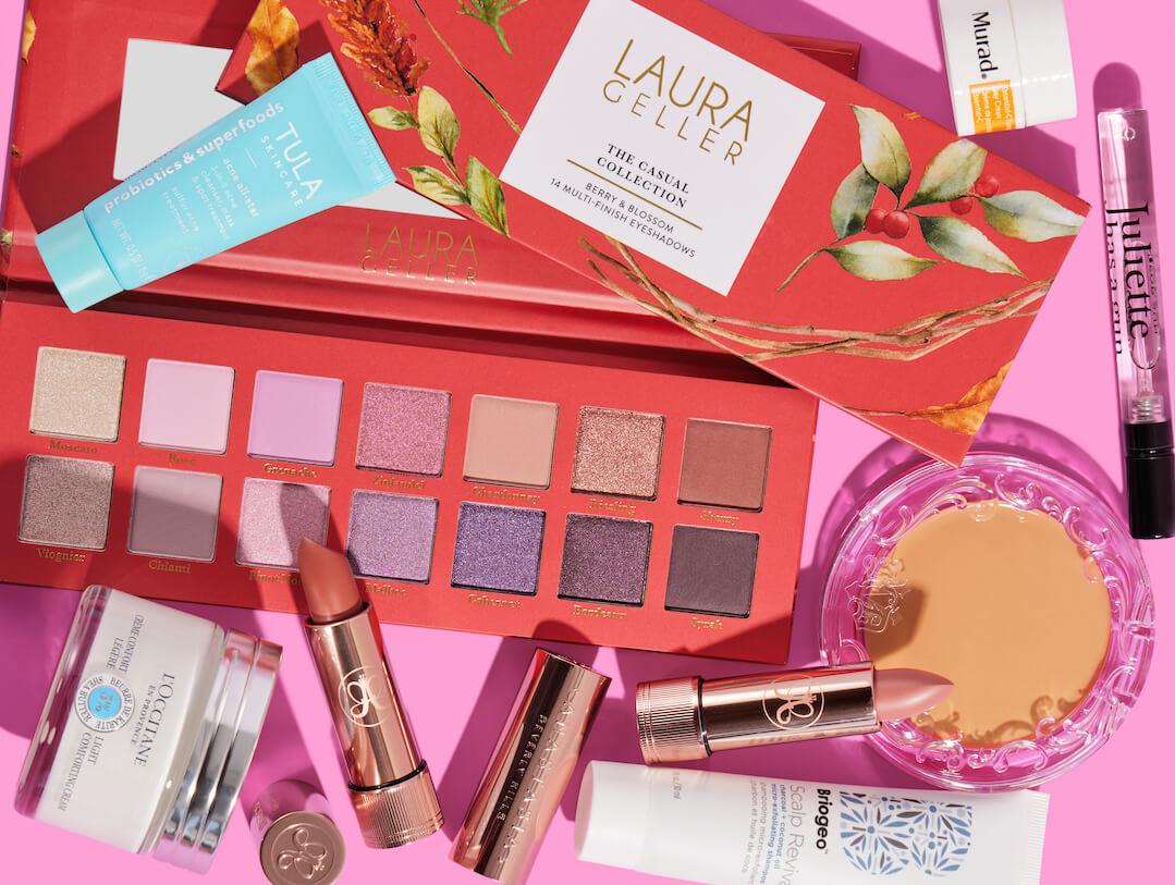 Beauty and makeup products from various brands scattered on pink background Desktop