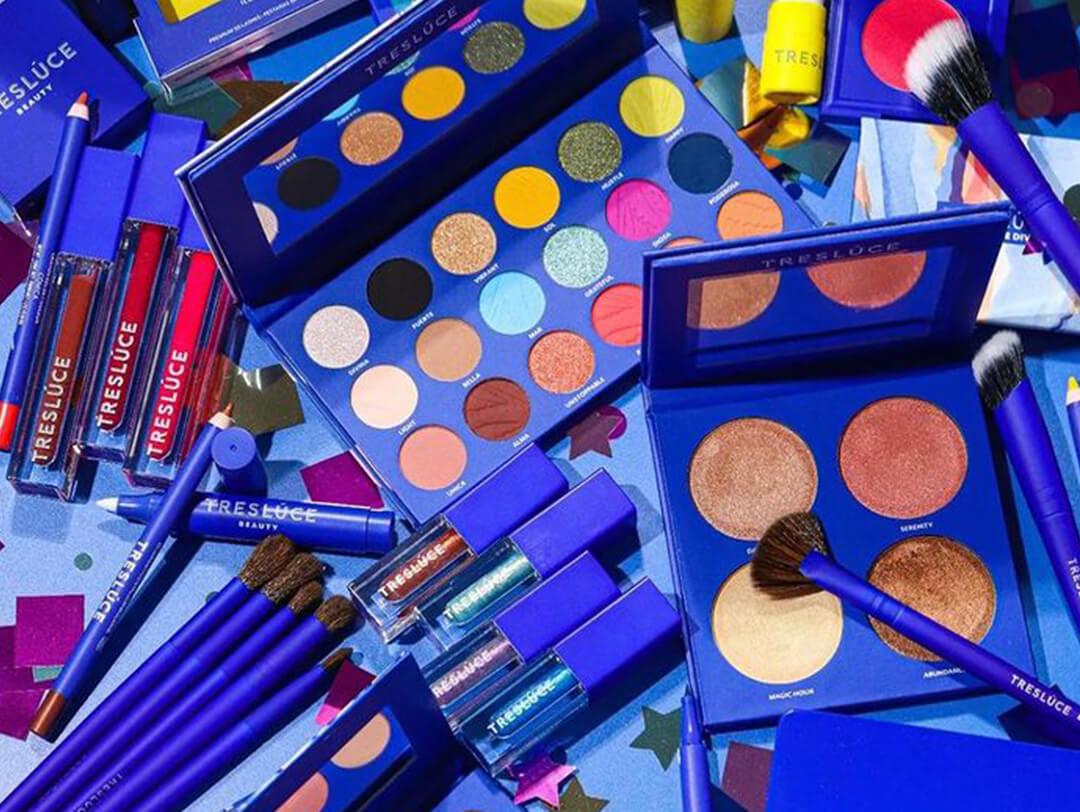A flatlay of different and colorful Treslúce products on a blue background Desktop