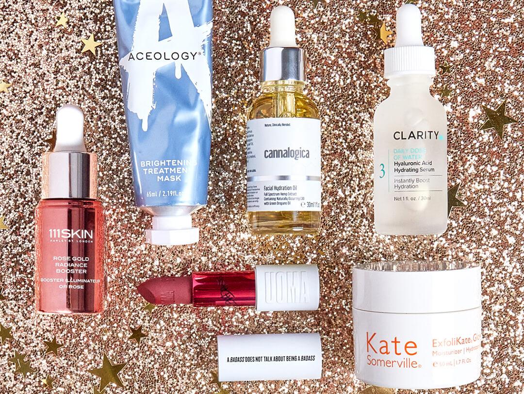 Beauty products from various brands on sparkly surface Desktop