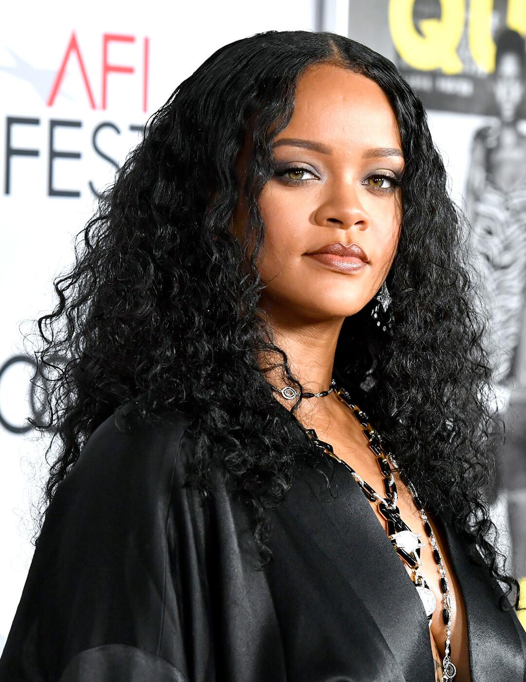 Rihanna in a black satin dress rocking a wet hair look Desktop