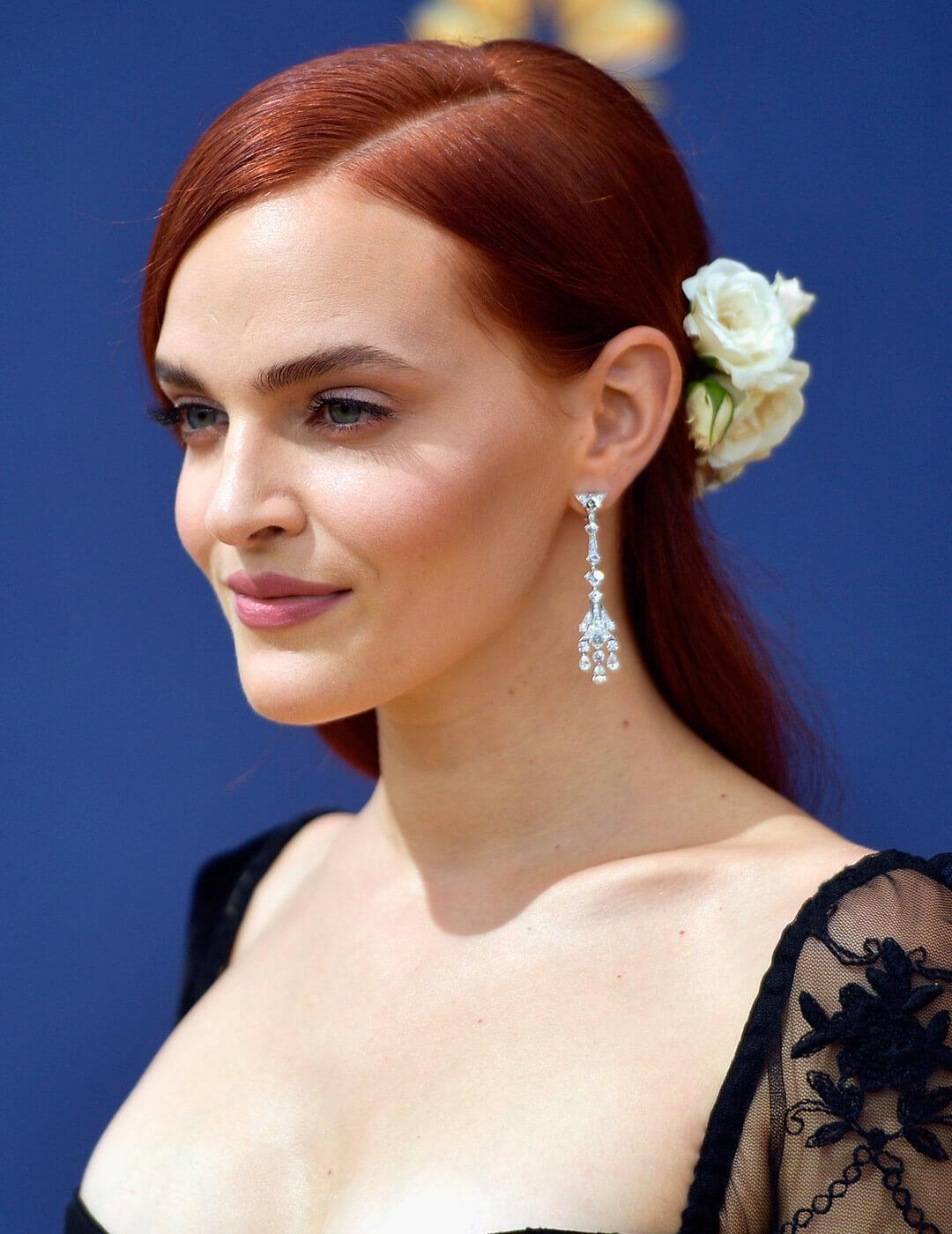 A photo of Madeline Brewer with a white rose hair accessory Desktop