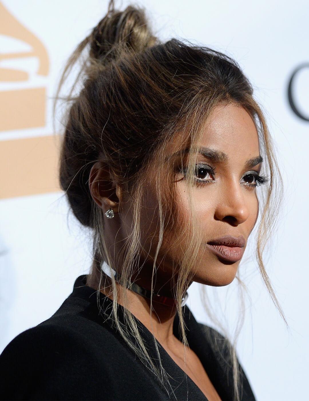 Close-up image of Ciara with an up-do hairstyle and loose bangs Desktop