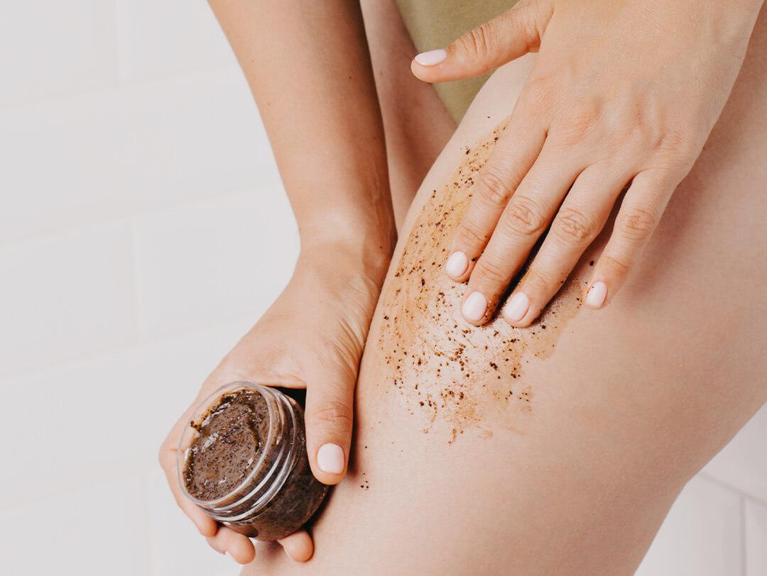 Woman using body scrub on her legs Desktop