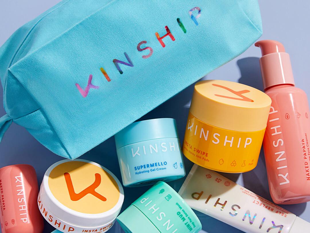 Beauty products from KINSHIP scattered on light blue background Desktop