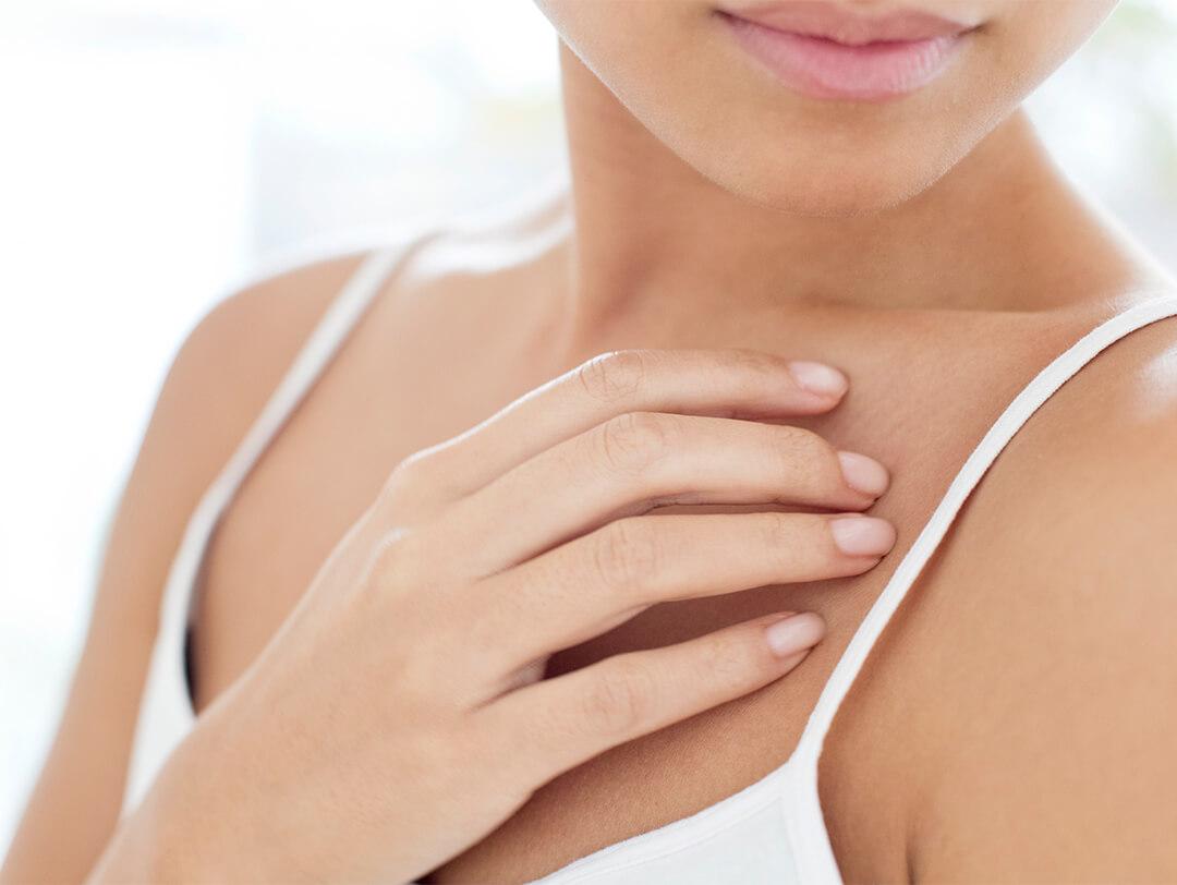 Close-up image of a woman holding her chest Desktop