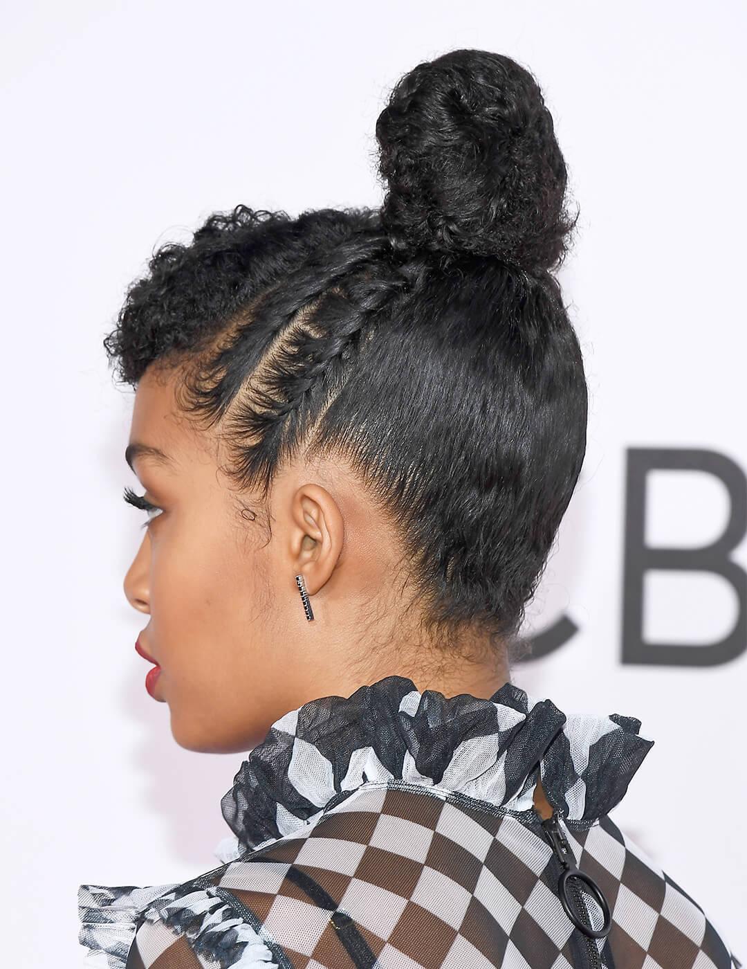 Yara Shahidi in a checkered black and white dress showing the back of her top knot and cornrows hairstyle Mobile