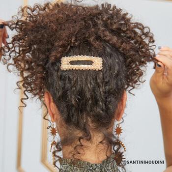 Christina Santini wearing a messy high pony tail with a big studded hair clip Mobile