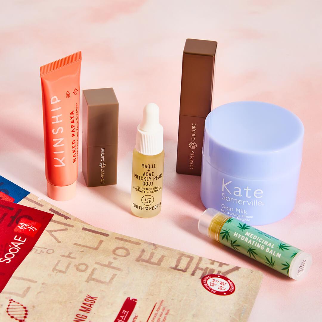 Image of skincare products from various brands on pink marble background Desktop