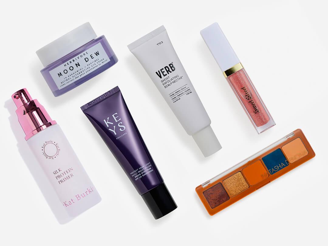 Skincare and makeup products from various brands on white background Desktop