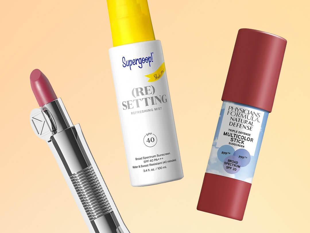 Makeup products with SPF from various brands on cream background Desktop