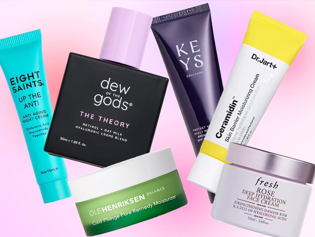 Close-up image featuring moisturizing products from Eight Saints, Dew of the Gods, Keys Soulcare, Ole Henriksen, Fresh, and Dr. Jart+, beautifully arranged in a flat lay on a pink gradient background Desktop