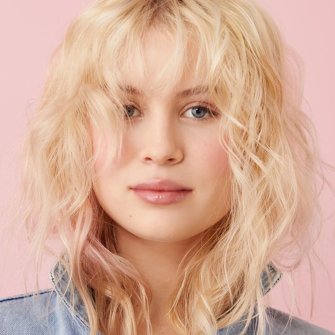 Close-up of a model rocking a tousled, textured hairstyle Mobile