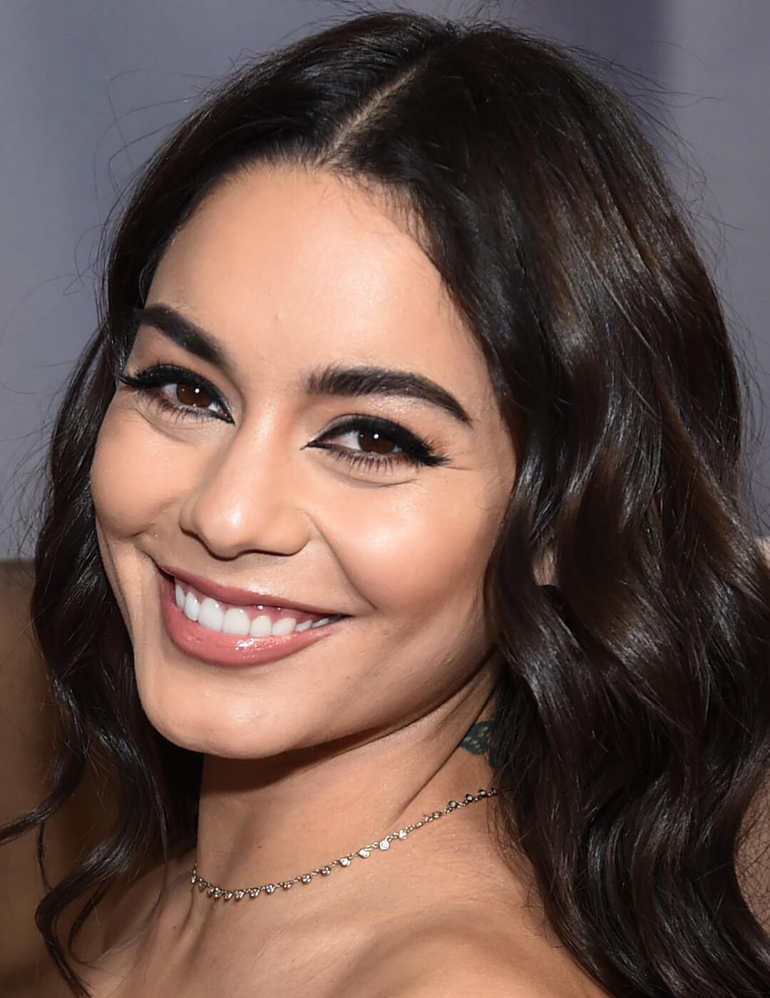 Smiling Vanessa Hudgens rocking a black eye makeup look with sharp inner corners Mobile