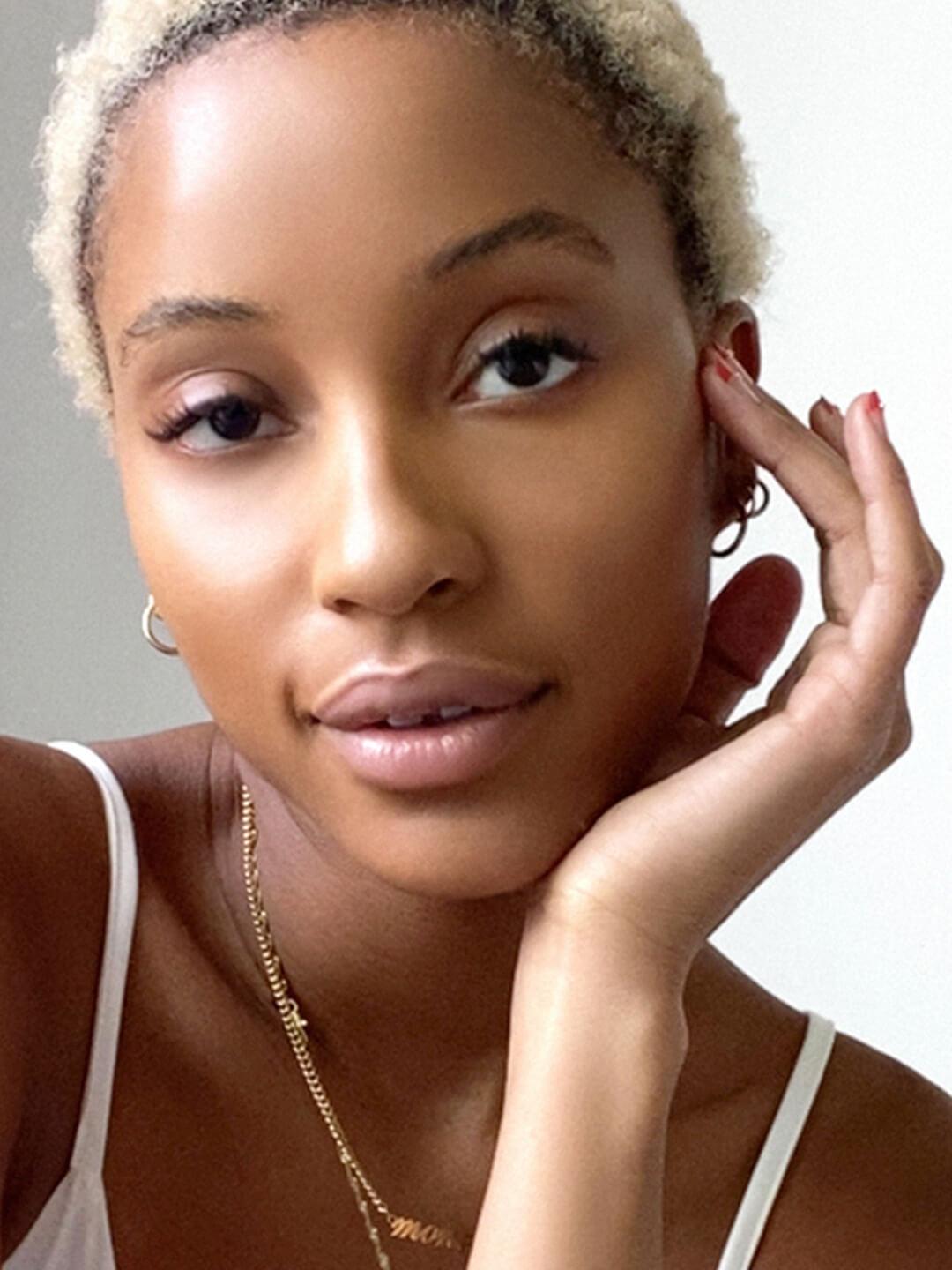 Close-up of a Black model posing and rocking a no-makeup makeup look Desktop