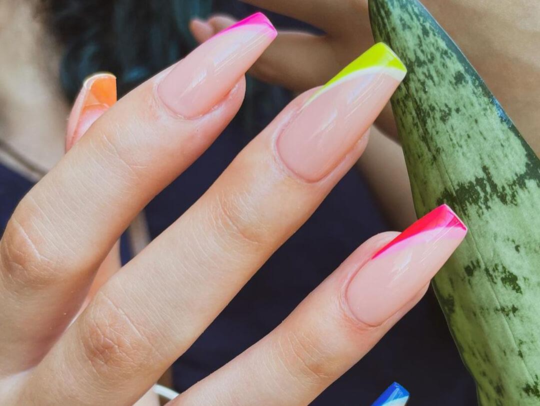A photo of a woman's hand showing a glossy nails with bright colored nail polish Desktop