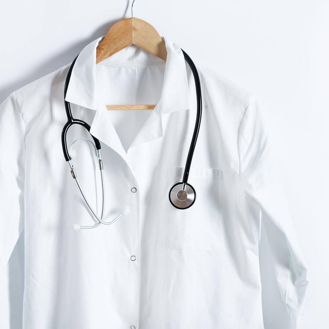 A picture of a white coat on a white background with a stethoscope hanging from it Mobile